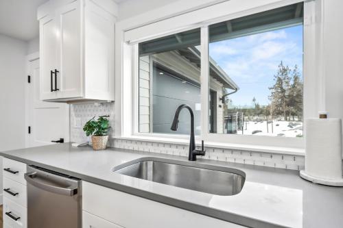 a kitchen with a sink and a window at OBRILEY in Bend