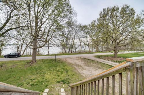 a car driving down a road next to a wooden fence at Cozy Illinois Retreat with Home Gym and River Views! in Chillicothe