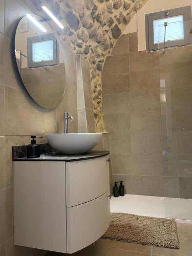 a bathroom with a sink and a mirror at Dimora del Torchio Piscina panoramica e Jacuzzi in Soiano del Lago