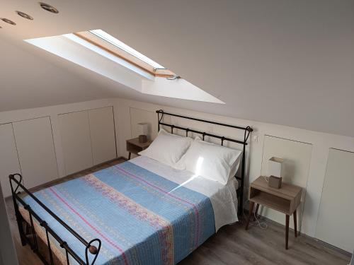 a bedroom with a bed and a skylight at Airport Loft , paiania in Paianía