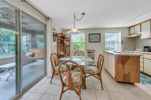 a kitchen and dining room with a table and chairs at Beach Haven by Emerald Coast Retreats in Panama City Beach