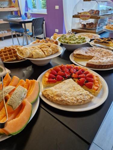 a table full of different types of food on plates at Albergo Trattoria Italia in Desenzano del Garda
