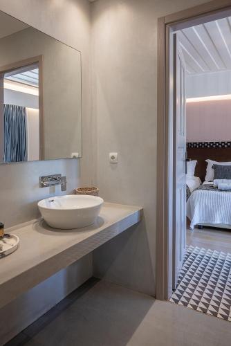 a bathroom with a sink and a mirror at Vranas Ambiance Hotel in Chania Town