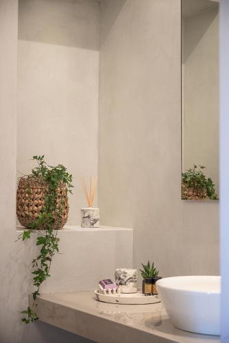 a bathroom with a counter with a sink and a mirror at Vranas Ambiance Hotel in Chania Town