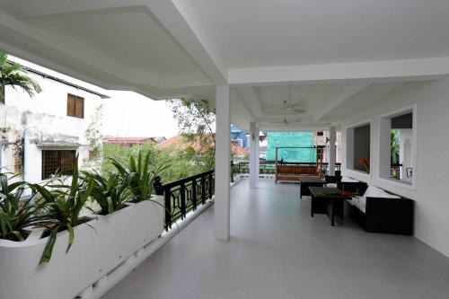 a living room with plants on a balcony at Bamboo9 Boutique in Phnom Penh