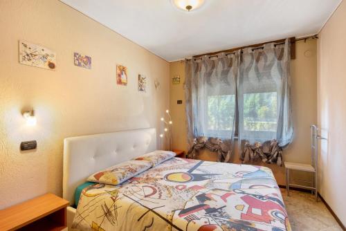 a bedroom with a bed and a window at Casa Michod Chatillon - Nonna Genia in Châtillon