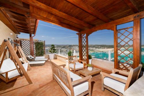 a patio with chairs and a view of the water at L’Attico sul Mare - Exclusive Penthouse, Vieste in Vieste