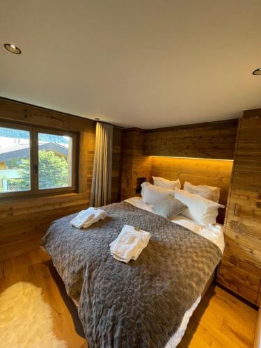 a bedroom with a large bed with two towels on it at Verbier Luxury Apartment - Newly Renovated - 4 Guests in Verbier