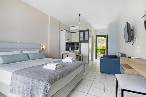 a bedroom with a bed and a living room at Sunset Premium Studio 7 in Agios Nikitas