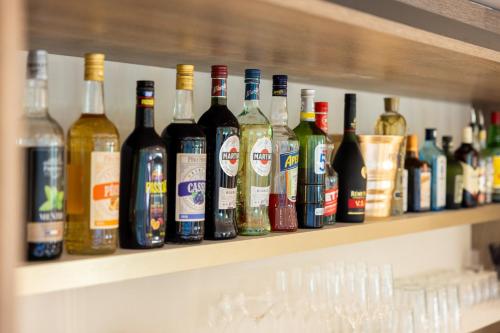 a shelf filled with lots of bottles of wine at Staybridge Suites - Cannes Centre by IHG in Cannes