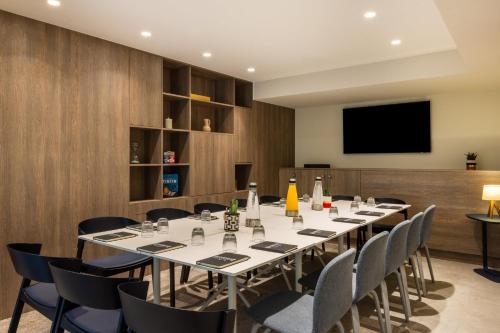 a conference room with a long table and chairs at Staybridge Suites - Cannes Centre by IHG in Cannes