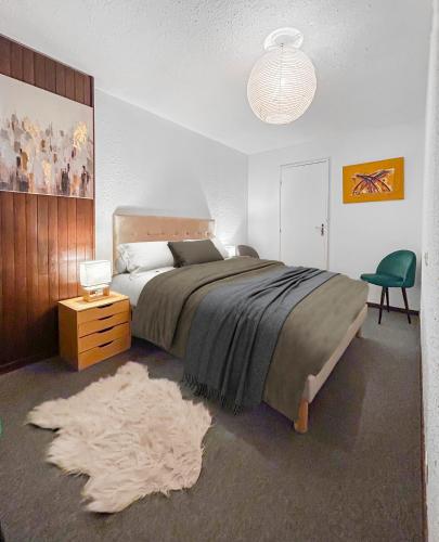 a bedroom with a large bed and a rug at Refuge Montagnard à Montgenèvre in Montgenèvre
