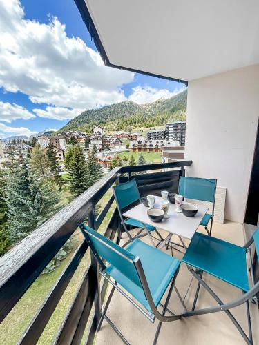 a balcony with a table and chairs with a view at Refuge Montagnard à Montgenèvre in Montgenèvre