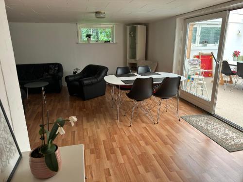 a living room with a table and chairs at Skovbrynet 2 The place for you in Løkken