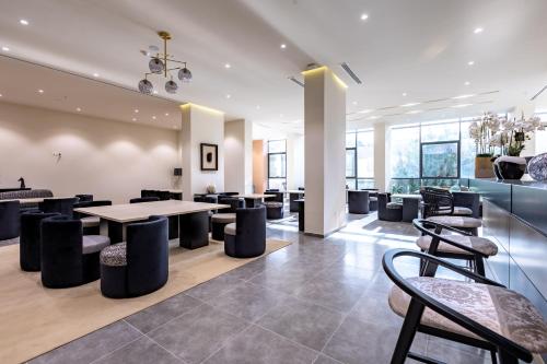 a lobby with a table and chairs in a building at Hôtel Ben Aouda & Spa in Tipaza