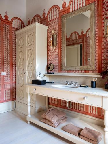 a bathroom with a sink and a mirror at Elizabeth Country House, a Member of Design Hotels in Minerbio