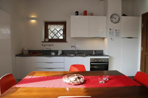 a kitchen with a table with a red napkin on it at Cjase Dai Fornasirs 2 in Raveo