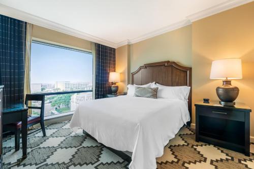 a bedroom with a large bed and a window at Omni Fort Worth Hotel in Fort Worth