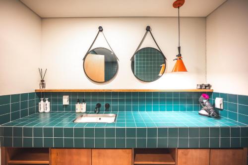 a bathroom with a sink and two mirrors at Pet-friendly camping theme house anseongcamp96 by dazayo in Seogwipo