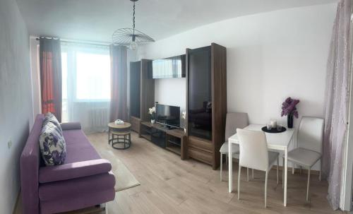 a living room with a table and a dining room at Apartament Perła in Gdańsk