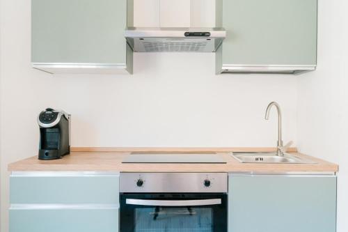 a kitchen with a sink and a counter top at FG Vacanze in Alghero