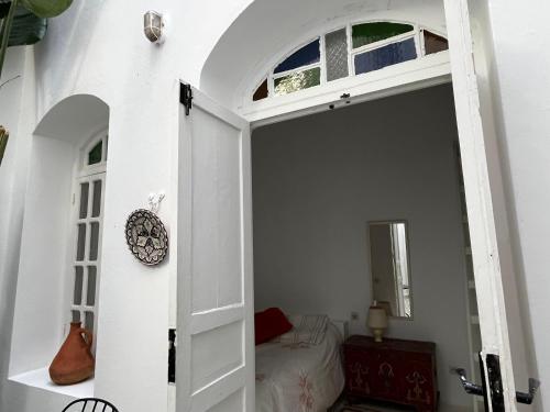 an open door to a bedroom with a bed at casabonita in Asilah