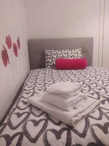 a bedroom with a bed with towels on it at Dimora Ninfee in Rome