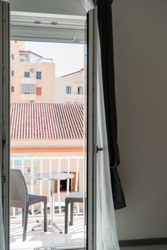 a sliding glass door with a table and chairs outside at FG Vacanze in Alghero
