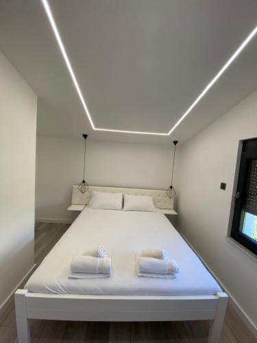 a bedroom with a bed with two towels on it at Villa paradise in Podstrana