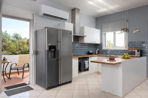 a kitchen with a stainless steel refrigerator at Villa Bella with Private Pool and Hot Tub in Lardos