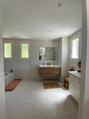 a bathroom with a tub and a sink and a mirror at Le Repos du Keyrié in Saint-Marc-Jaumegarde