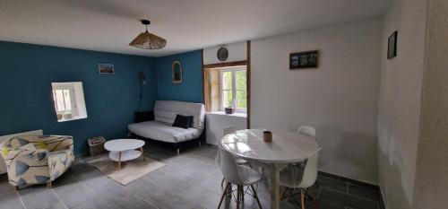 un salon avec un canapé et une table dans l'établissement Au doux rêve, à Puyfebert