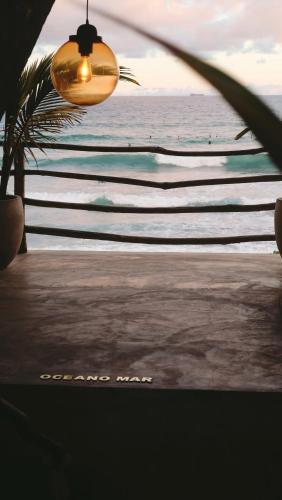 a view of the beach with surfers in the water at Morena Boutique Hotel Weligama in Midigama