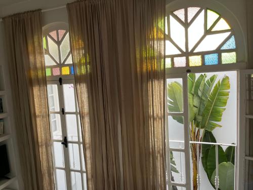 two windows in a room with stained glass at casabonita in Asilah