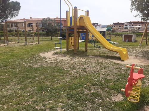 a playground with a slide in a park at Porto San Paolo a 50 mt dal mare in Porto San Paolo