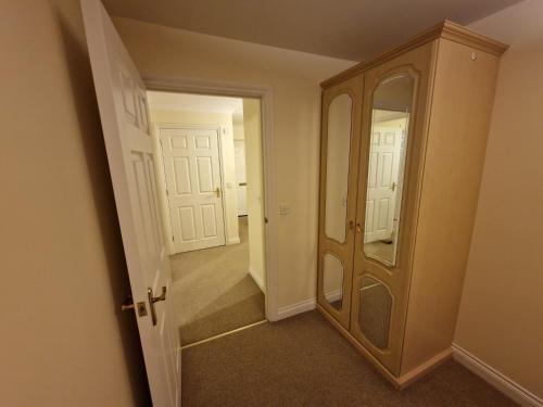 a hallway with a mirror and a dresser in a room at Dellside Apartments in Southampton