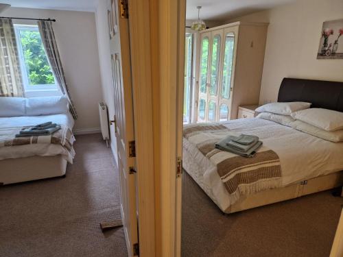 a bedroom with a bed and a room with two windows at Dellside Apartments in Southampton