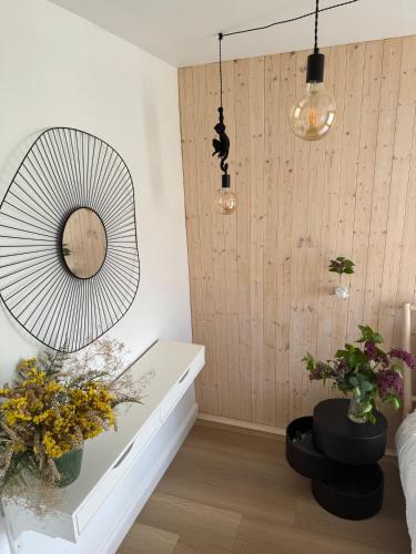 a room with potted plants and a large fan at Seaside luxury apartment in Tūja