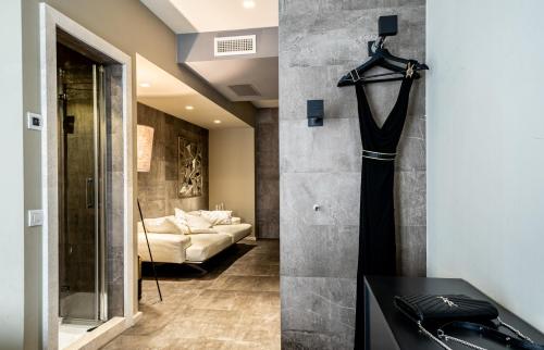 a room with a black dress hanging on a wall at Neko Boutique Hotel in Cagliari