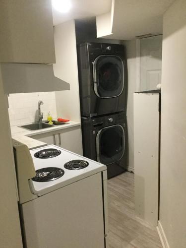 a kitchen with a stove and a refrigerator at Lower Unit Entire Apartment in Cambridge