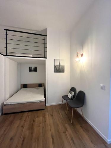 a bedroom with a bed and a chair at Designed flat in Menton center in Menton