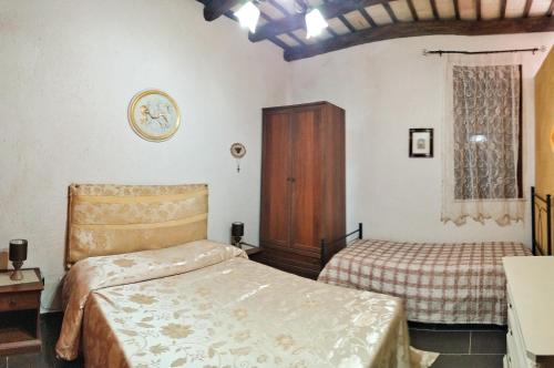 a bedroom with two beds and a cabinet and a window at Appartamenti Fior Di Loto in Trapani