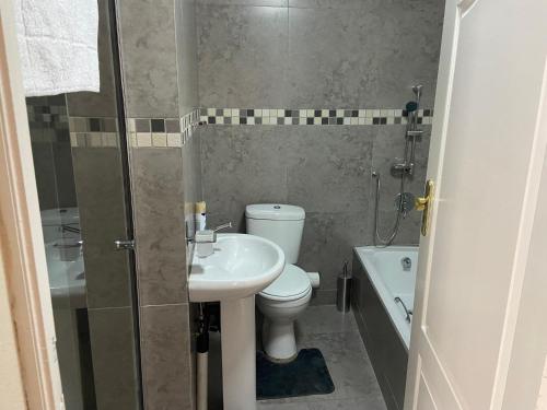 a bathroom with a toilet and a sink and a shower at Mokapelo Life Style Guest House in Bela-Bela