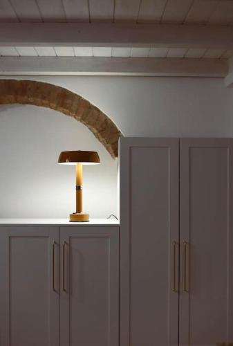 a lamp sitting on top of two cabinets in a room at Filangieri 28 in Bernalda