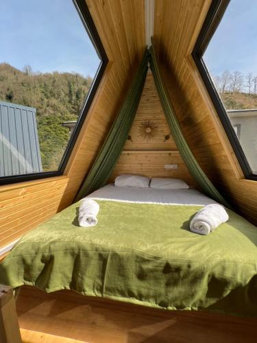 a bed in a room with a large window at Hill sunny2024 in Zemo Jocho