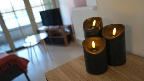 three black candles sitting on top of a table at * * * Donjon du Bijoutier * * * Wifi+Clim+Terrasse in Beaucaire