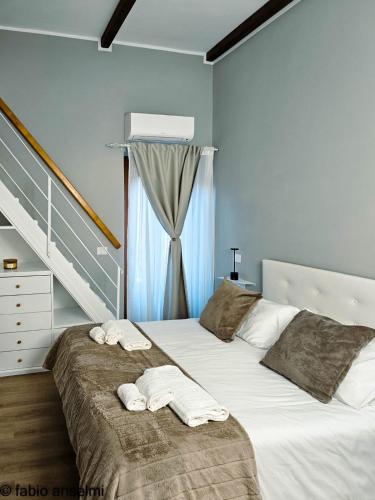 a bedroom with two beds with towels on them at Casa gioia in Bracciano