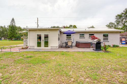 a small white house with a patio and a yard at Private Hot Tub and Grill Avon Park Getaway! in Avon Park