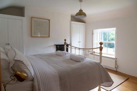 a bedroom with a bed with two pillows on it at Charlestown cottage, Woodburner, Gardens & Parking in Charlestown
