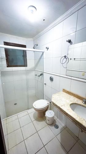 a bathroom with a shower and a toilet and a sink at Casa Maresias Canto do mar - 50m da praia in Maresias